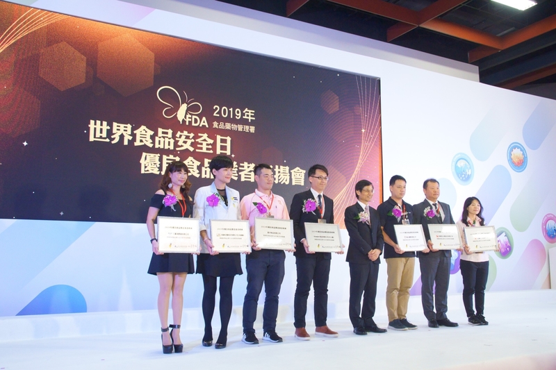 Group of people on stage receiving an award