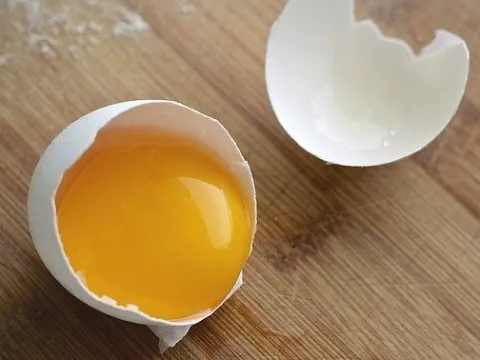 Cracked open egg showing the yolk