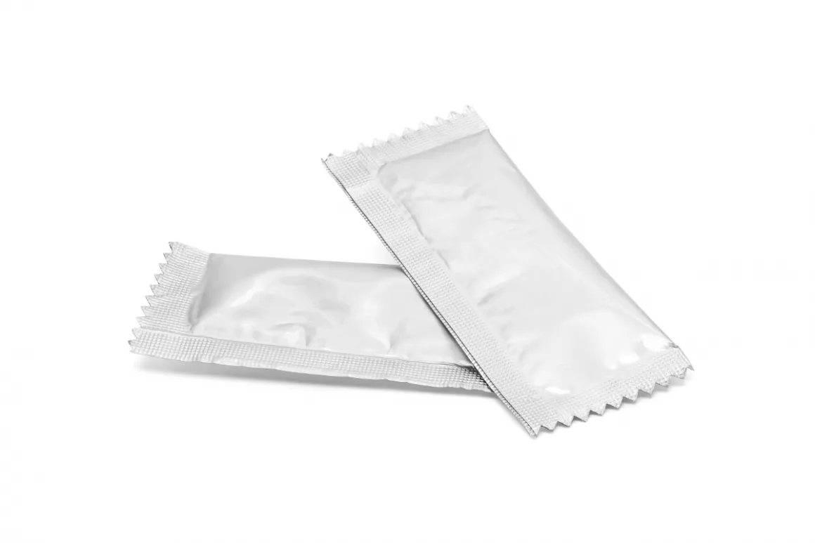 Two powder sachets on white surface