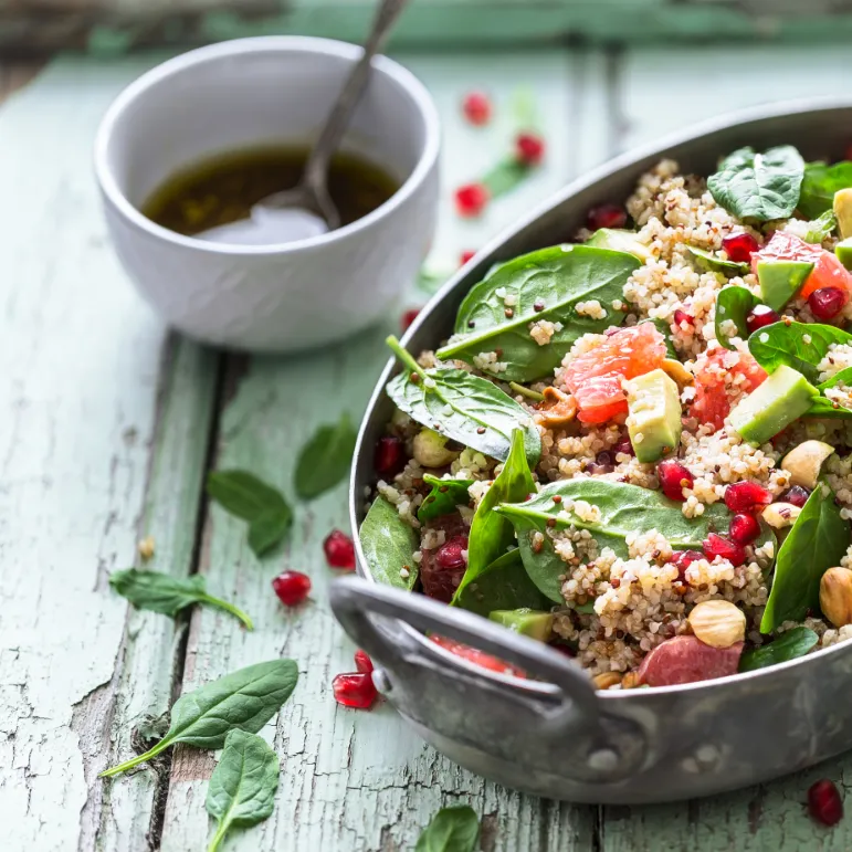 Bowl of fresh salad om a wooden table