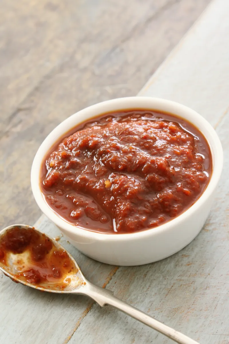 Chunky red sauce in a white bowl