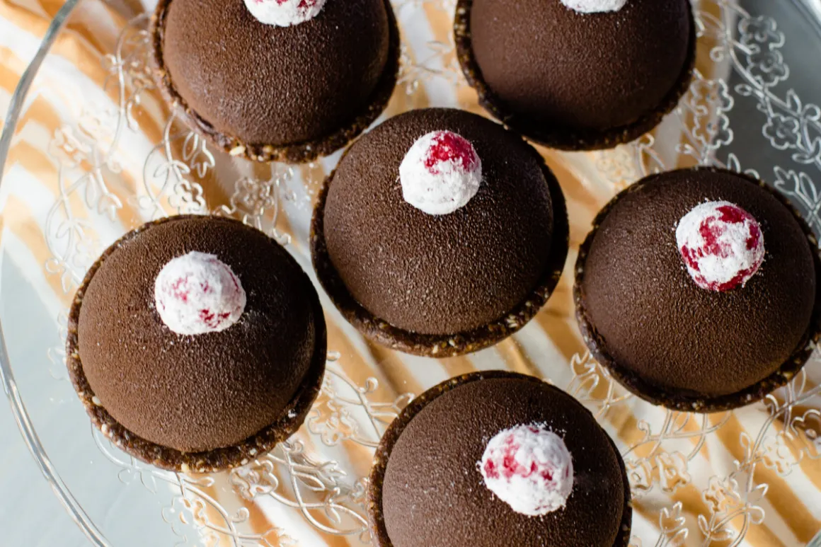 Multiple brown cupcakes with white icing