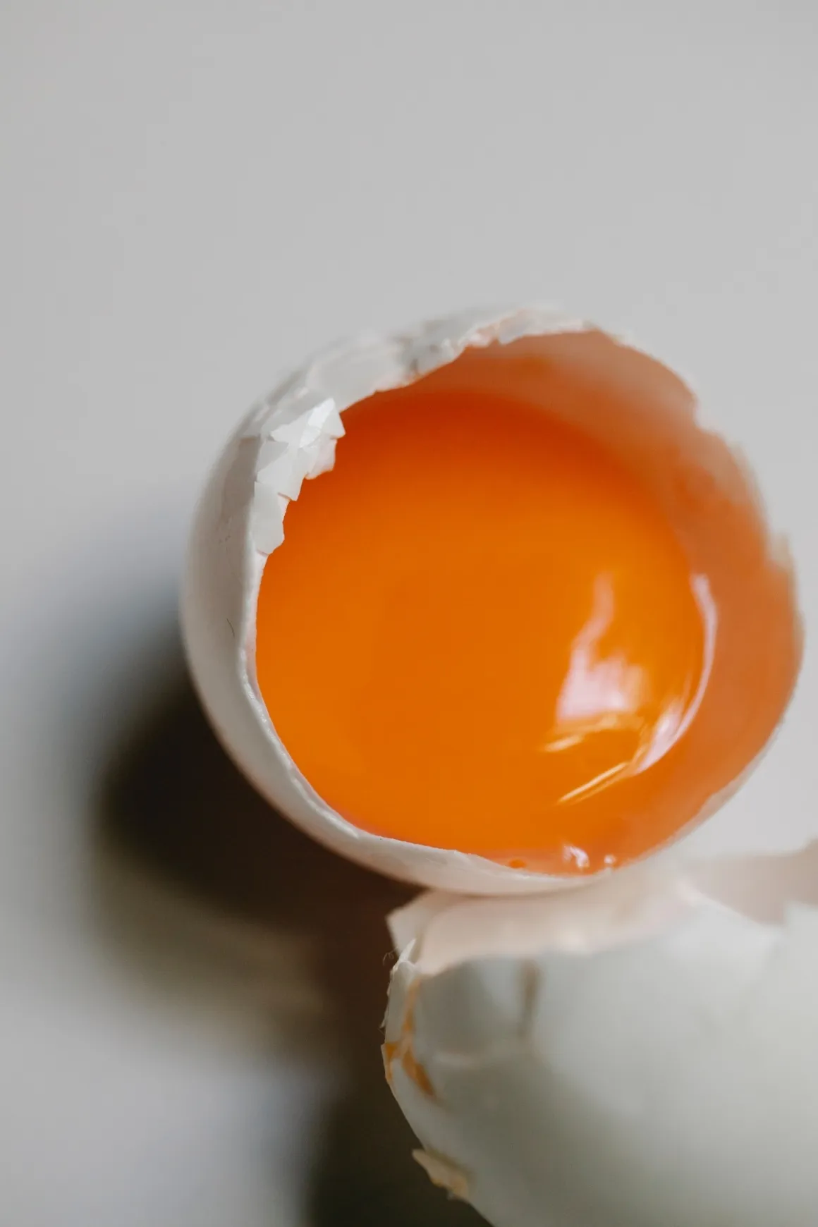 Cracked open egg showing the yolk