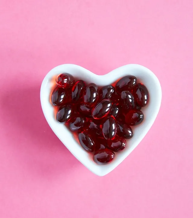 Softgel capsules in a heart-shaped bowl