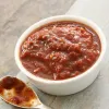 Red chunky sauce in white bowl
