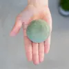 A hand holding a round soap