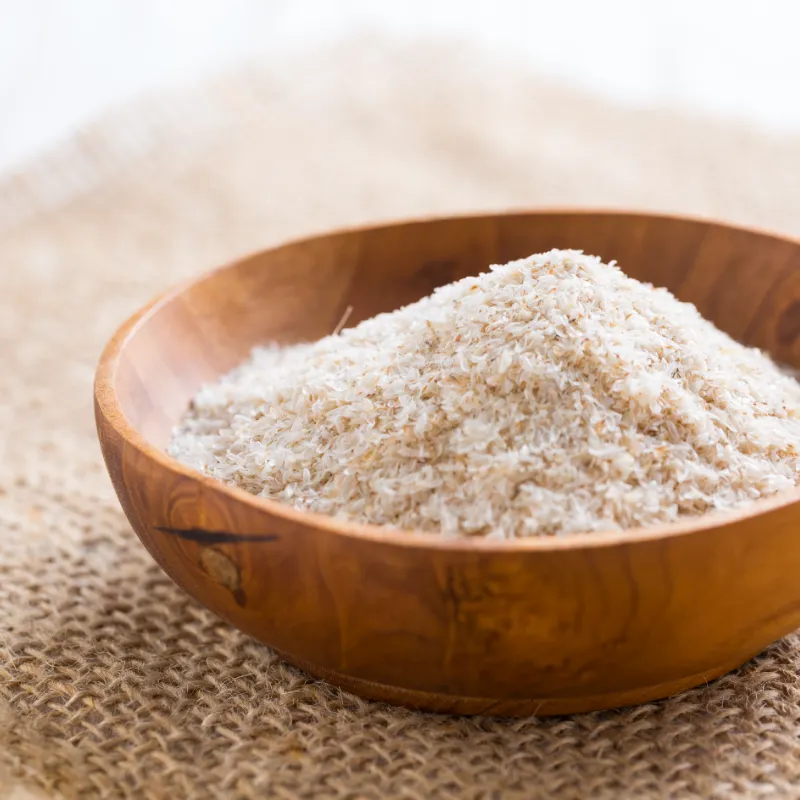 Wooden bowl filled with white powder standing on a rough fabric