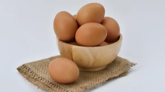 Wooden bowl filled with eggs