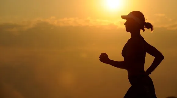 A female runner in a sunset scene