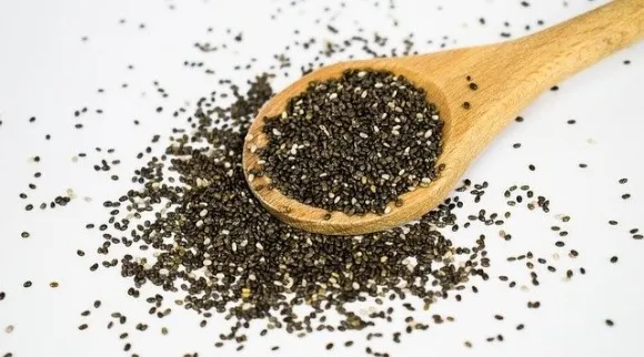 A wooden spoon filled with chia seed