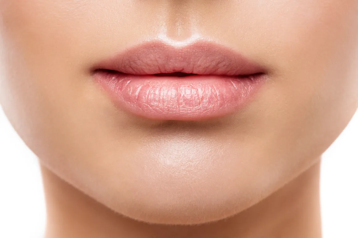 Close up of a womans lower face showing smooth skin and full lips