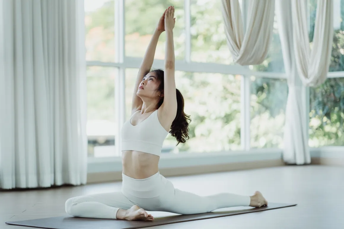 Woman in sports attire doing a yoga pose